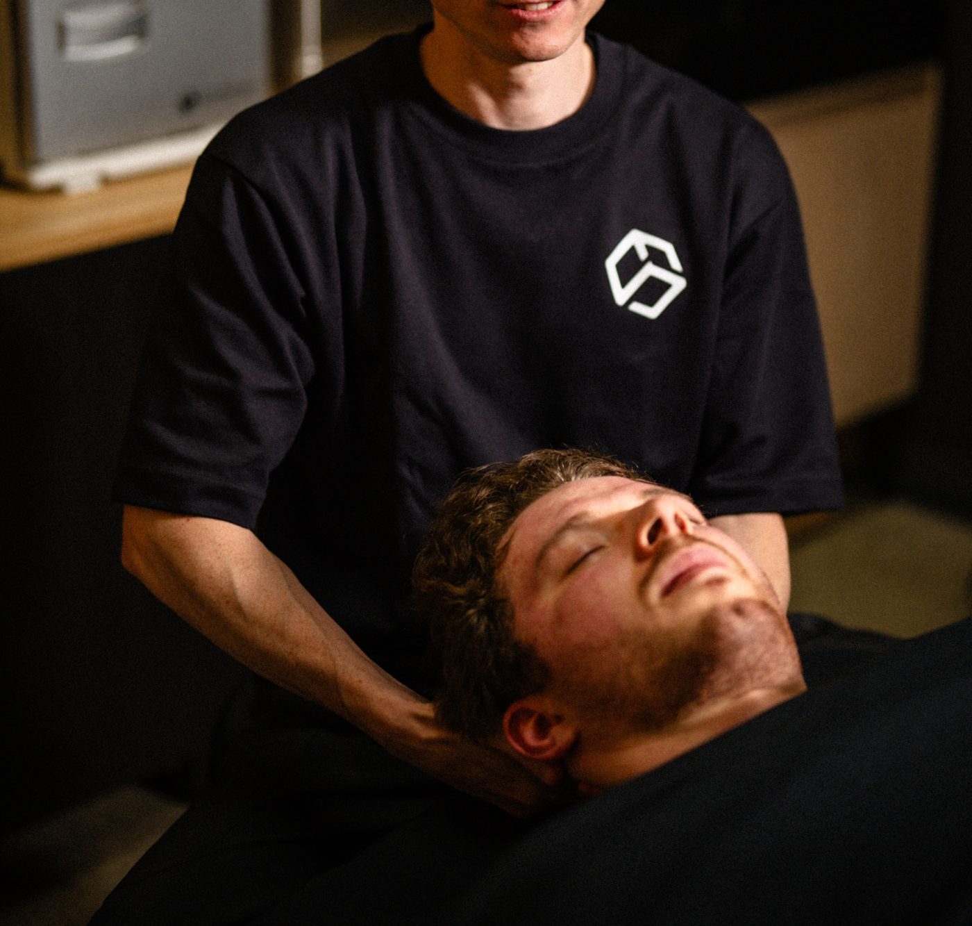 Daniel treating a client's neck on the treatment table